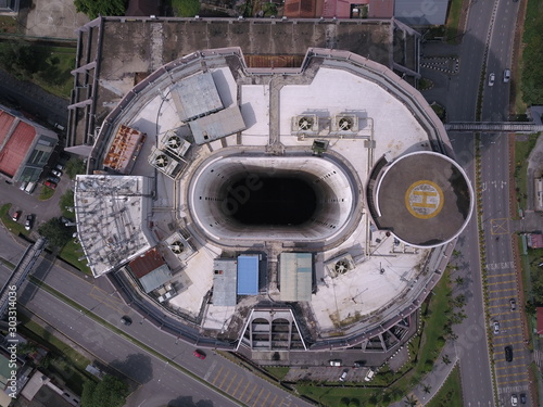 Kuching, Sarawak / Malaysia - November 15 2019: Creative shot - an aerial top down view of a donut shaped building in Kuching, the island of Borneo. The core of the building was empty.