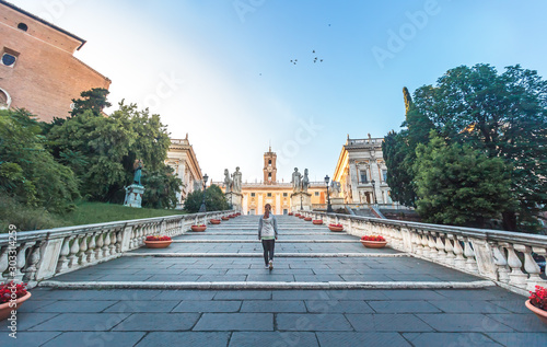 Photography Girl walking up the Capitoline Hill at Dawn in the Morning, Rome, Italy