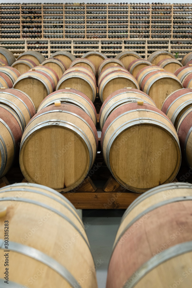 Wooden wine barrels for storage in wine cellar Wooden wine barrels for storage in wine cellar