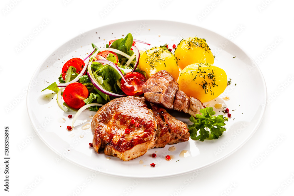 Grilled steak with boiled potatoes and vegetable salad Grilled steak with boiled potatoes and vegetable salad