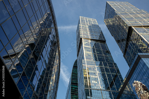 Modern business center in Moscow city. Modern urban architecture, glass skyscraper, office building on a sunny day, view from below.