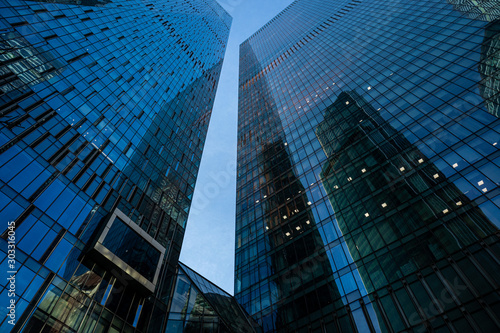 Modern business center in Moscow city. Modern urban architecture, glass skyscraper on a clear evening, view from below.