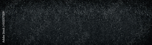 Wide dark weathered concrete wall texture. Abstract widescreen background