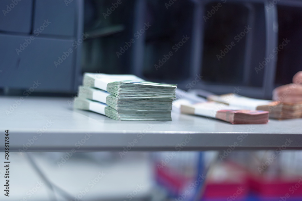 Bank employees sorting and counting money inside bank vault. Large amounts of money in the bank. Bank employees sorting and counting money inside bank vault. Large amounts of money in the bank.