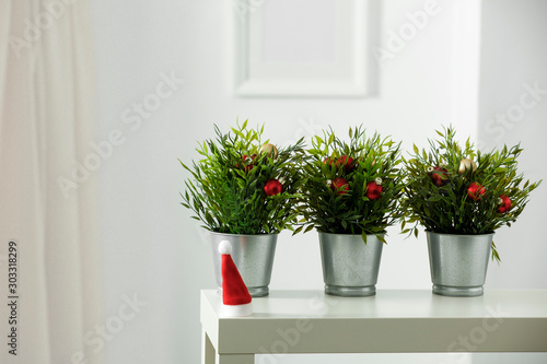 Wooden shelf with space for your decoration. White wall with frame picture background. Christmas composition.Winter time. Copy space. 