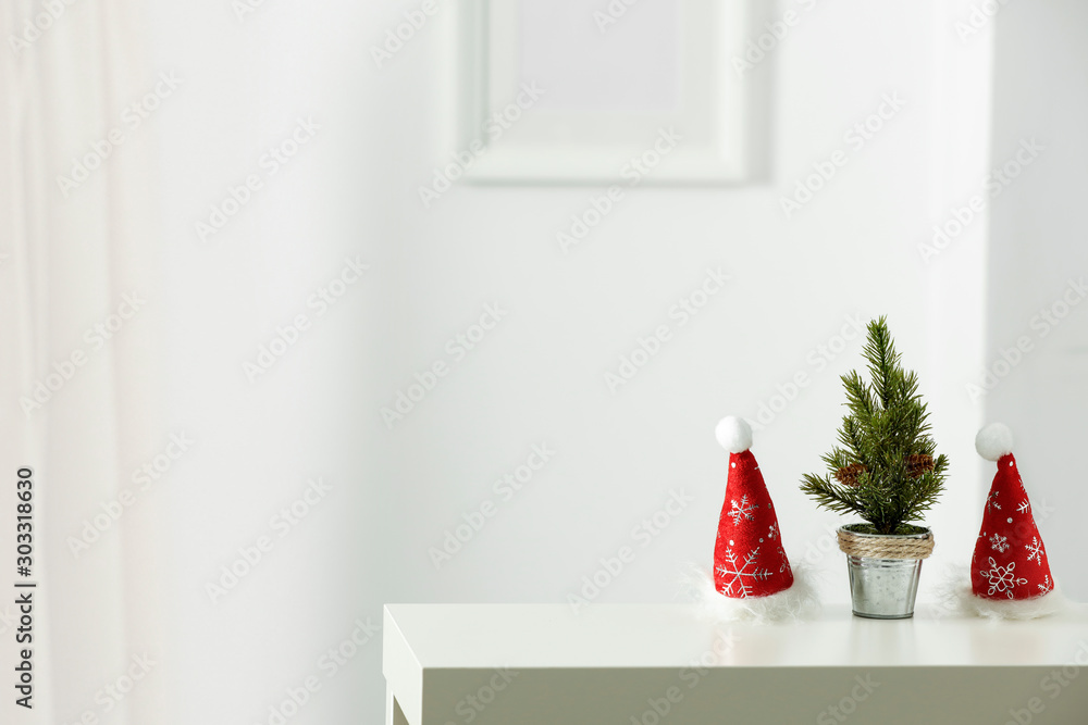 Fototapeta premium Wooden shelf with space for your decoration. White wall with frame picture background. Christmas composition.Winter time. Copy space. 