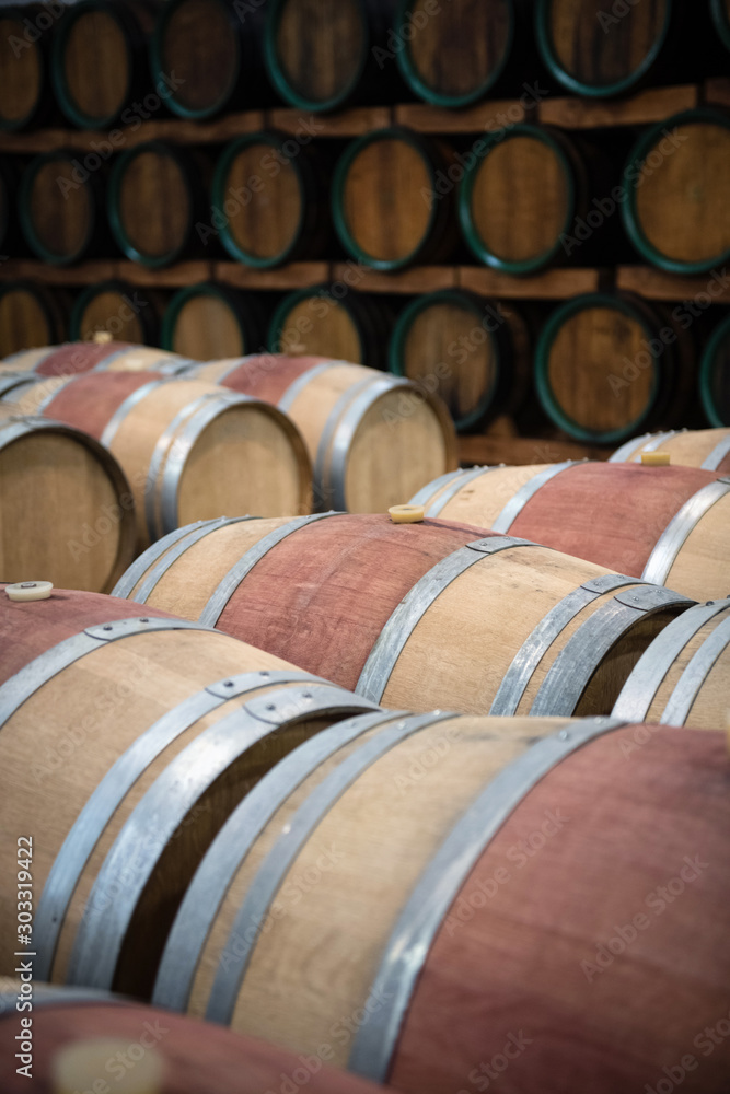 Wooden wine barrels for storage in wine cellar