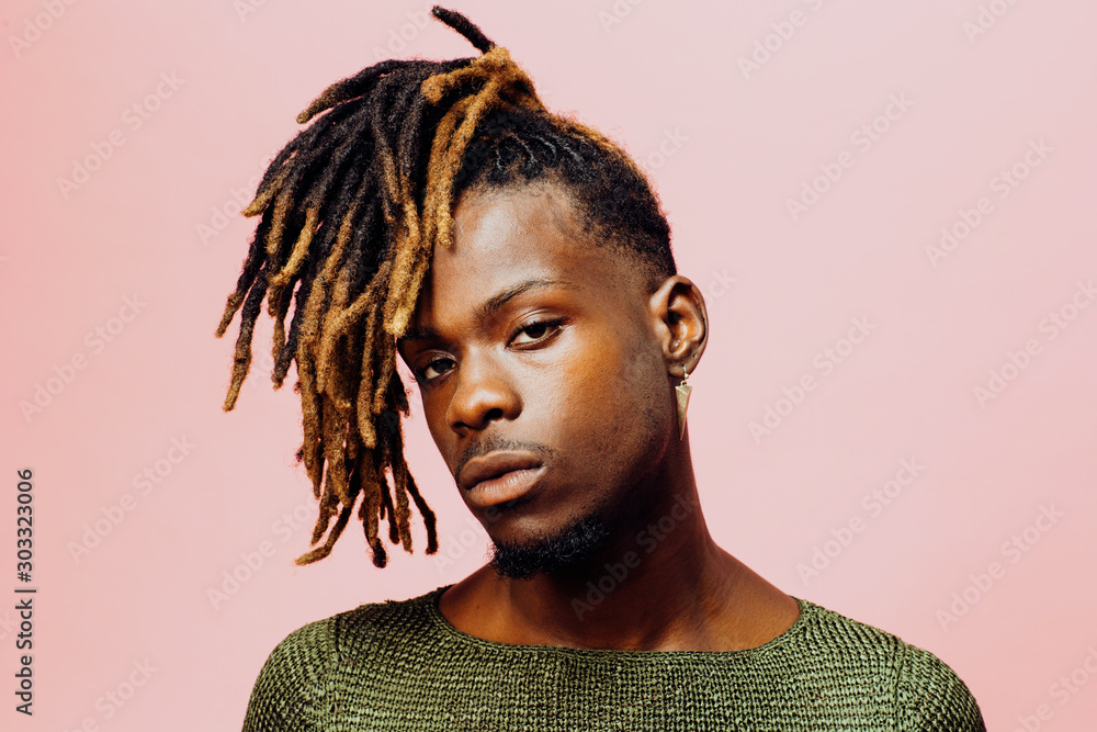Ταπετσαρία Portrait of a serious  young man in with cool dreadlocks hairstyle, isolated on pink