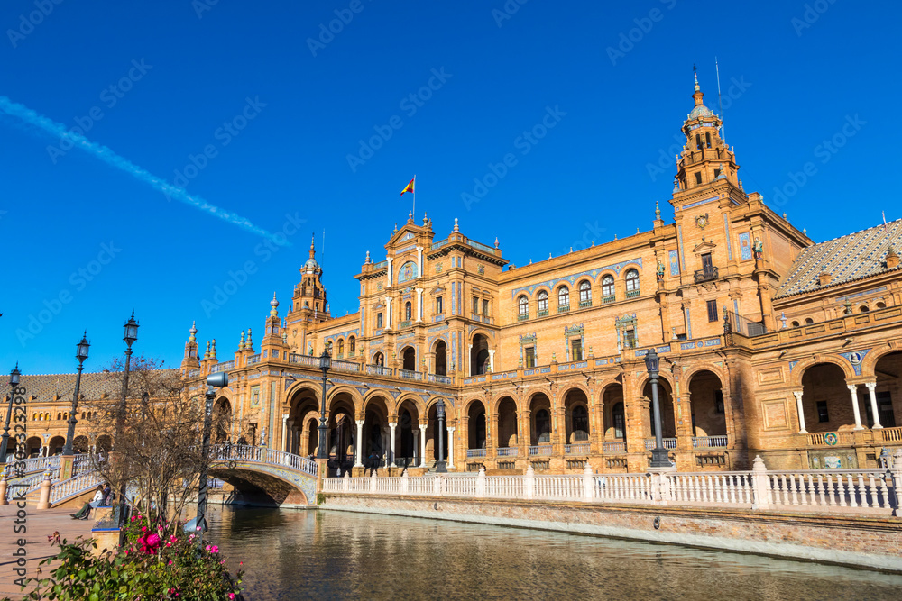 Building and river at the Spain Square (Plaza de Espana) in Seville (Sevilla) city, Andalusia, Spain. Example of Renaissance revival architecture. Bright Sunny day