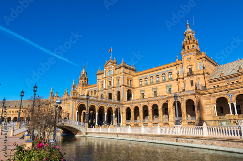 Building and river at the Spain Square (Plaza de Espana) in Seville (Sevilla) city, Andalusia, Spain. Example of Renaissance revival architecture. Bright Sunny day