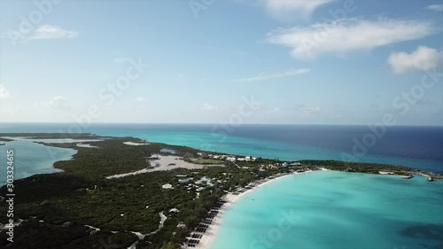 Drone footage of Half Moon Cay from above Bahamas island with stunning sandy beach and torcuse  shallow water photo