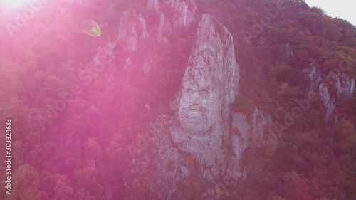 Aerial approch of statue of decebalus, the biggest statue in Europe, with lens flare. photo