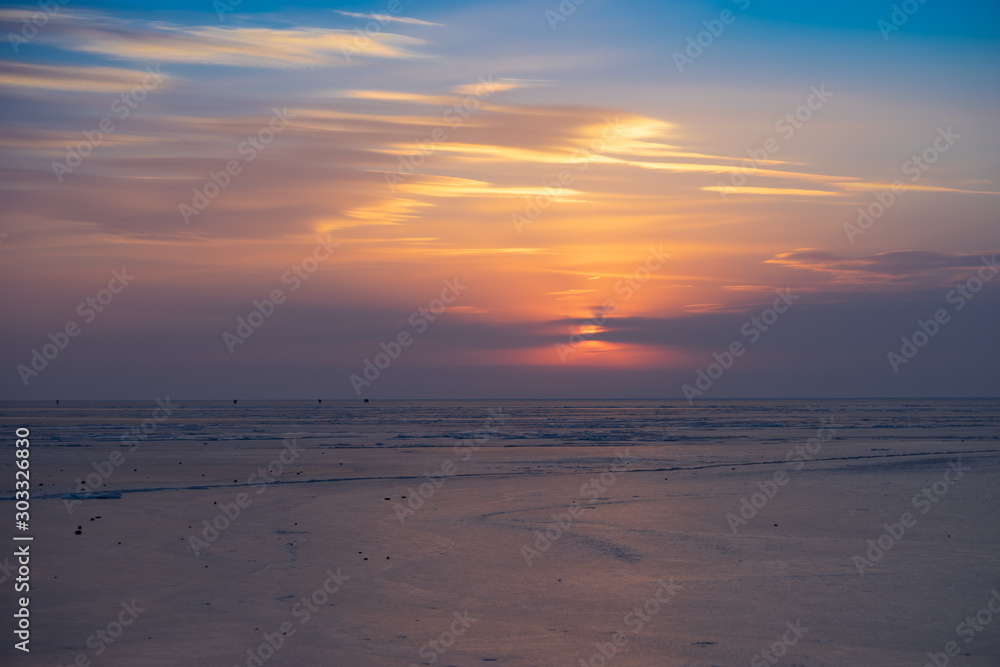 Sunset over the frozen surface of the Amur Bay.