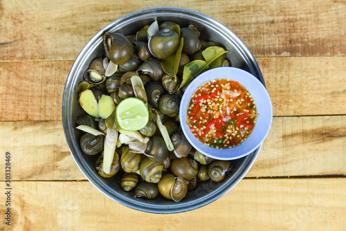 Pila ampullacea shellfish freshwater snail nautilus ammonite with spicy chili sauce - Boiled golden apple snail river cooked for Asian food in Thailand photo