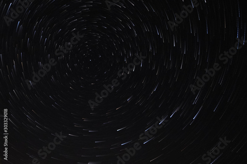 Long exposure starry sky, twisted tracks of stars.