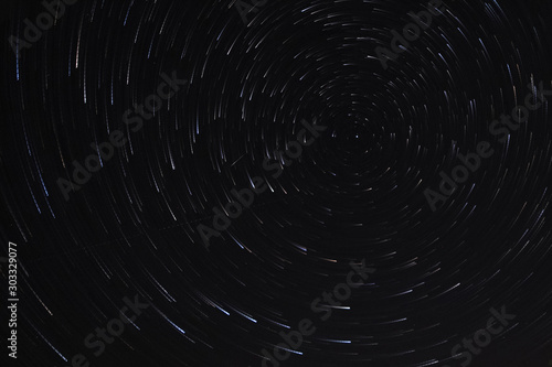 Long exposure starry sky  twisted tracks of stars.