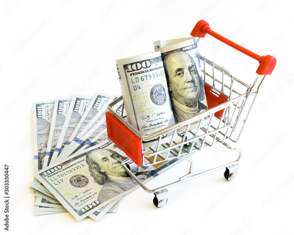 Studio shot stack of one hundred dollars banknote and tiny shopping cart isolated on white Studio shot stack of one hundred dollars banknote and tiny shopping cart isolated on white