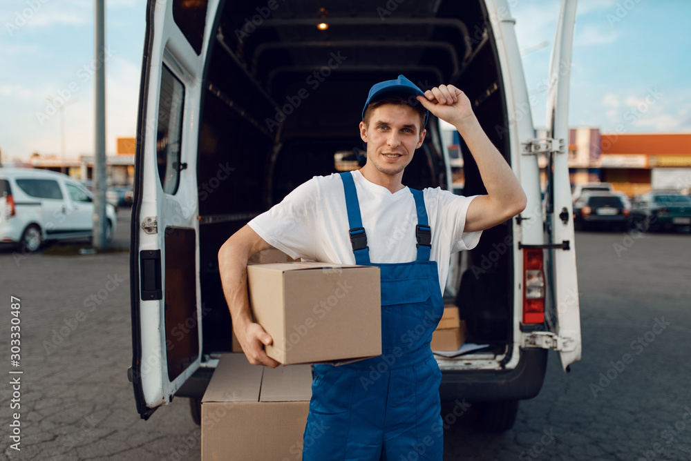 Loader in uniform holding box, delivery service Loader in uniform holding box, delivery service