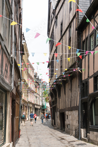 tourists visit the historic old city center of Rouen in Normandy with hits famous half-timbered houses