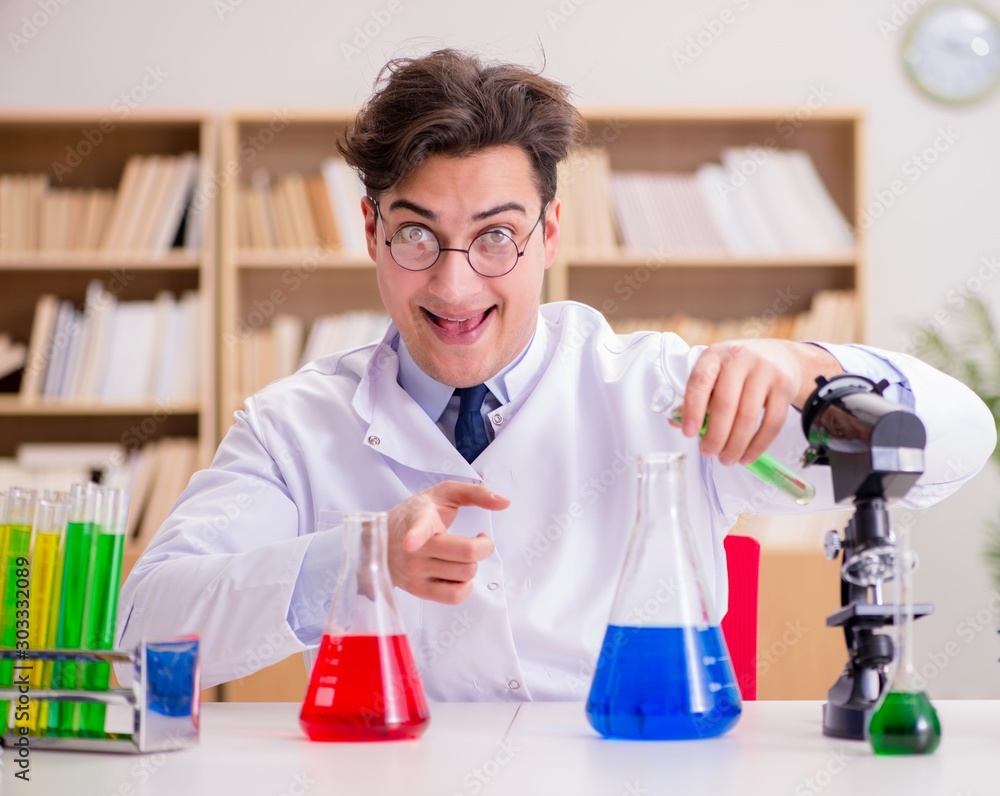 Mad crazy scientist doctor doing experiments in a laboratory Mad crazy scientist doctor doing experiments in a laboratory