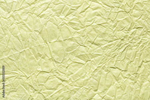 Crumpled paper texture in light beige color as part of your greeting card.