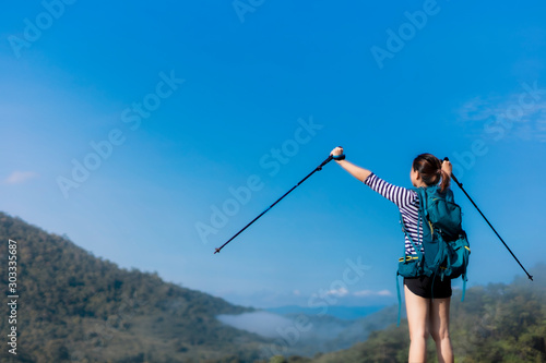 female hikers enjoying on the top of cliff mountian.