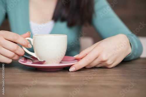 female hands holding with cup of coffee