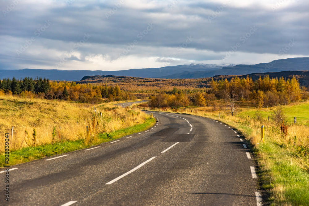 Iceland road landscape. Clouds and ocean on the horizon. Famous tourist attraction