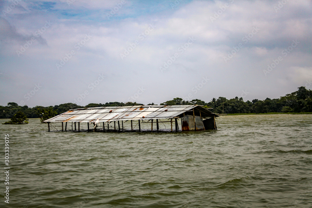 Sunamganj, Bangladesh- August 18, 2019. A house which is under water.