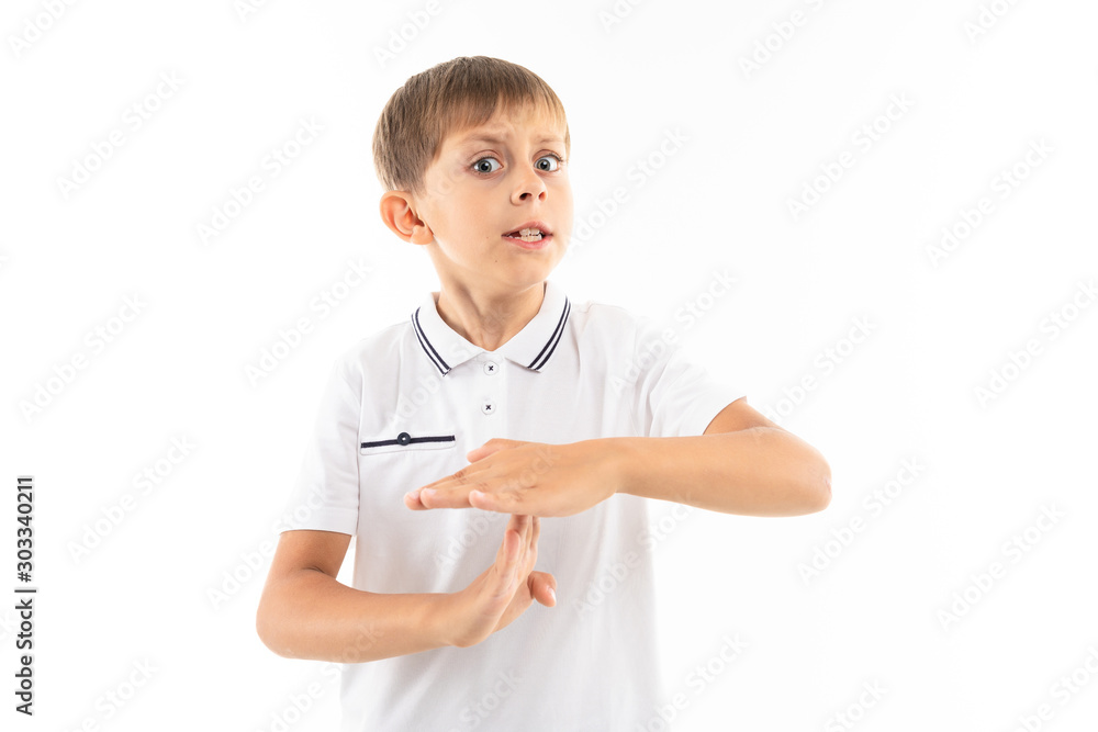 A little blonde boy shows timeout, picture isolated on white background A little blonde boy shows timeout, picture isolated on white background