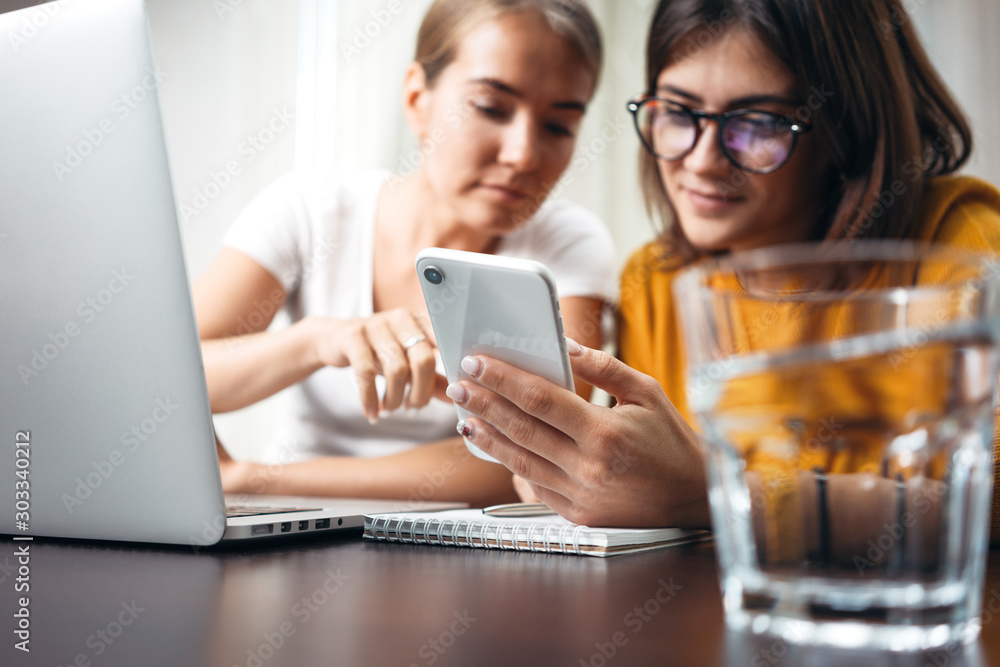 Handsome female manager meeting with office employee and discussing working. Pensive coworker with laptop meet with colleague Handsome female manager meeting with office employee and discussing working. Pensive coworker with laptop meet with colleague