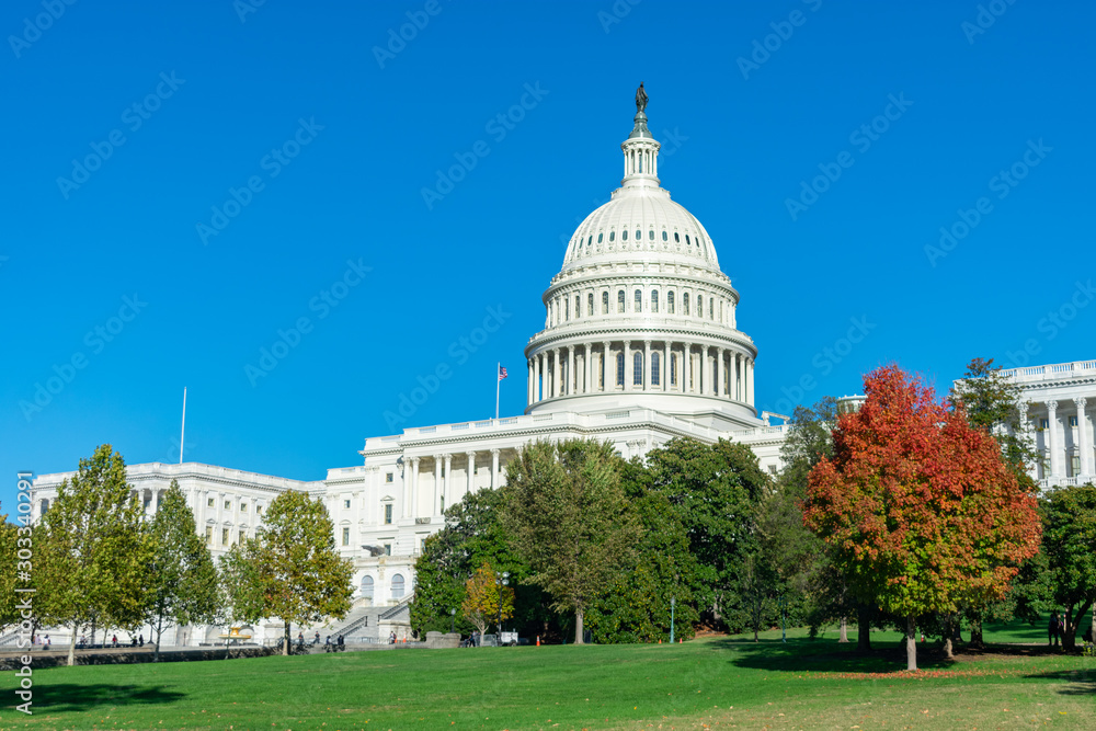 United States Capitol Building with Colorful Trees and a Green Lawn during Autumn in Washington D.C.
