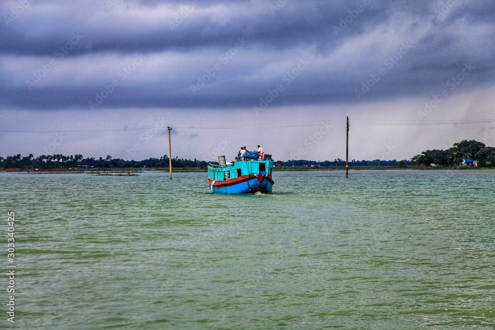 Sunamganj, Bangladesh- August 18, 2019. A beautiful view of Tanguar haor. And a boat with some people