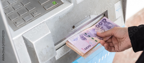 Konstfotografi Close up of hand withdraw money in Thai baht currency from bank machine