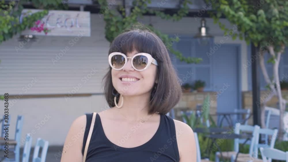 A young woman in a sunglasses. Slow motion video. A young woman in a sunglasses. Slow motion video.