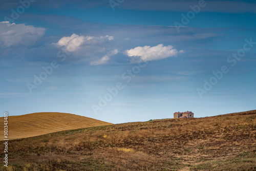 Beautiful Tuscany landscape with isolated house and clouds