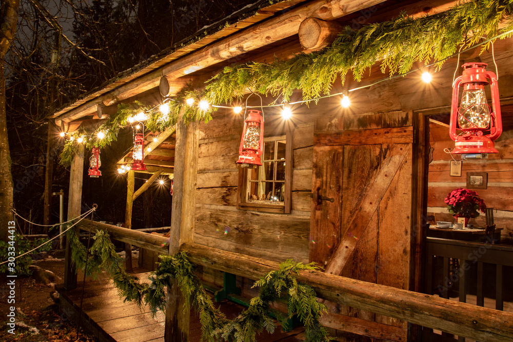 Tiny and Cozy house Cabin Exterior with Christmas lights. Ideal picture that brings up holiday spirit. Tiny and Cozy house Cabin Exterior with Christmas lights. Ideal picture that brings up holiday spirit.