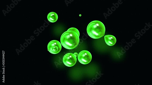 amasing abstract background of metaballs as if glass drops or spheres filled with green sparkles merge together and scatter move around cyclically in 4k. Looped seamless animation with glisten bubbles photo