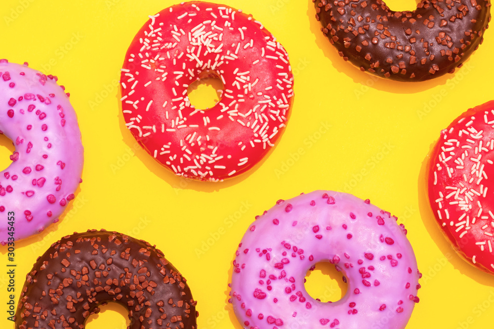 assorted donuts on a yellow background assorted donuts on a yellow background
