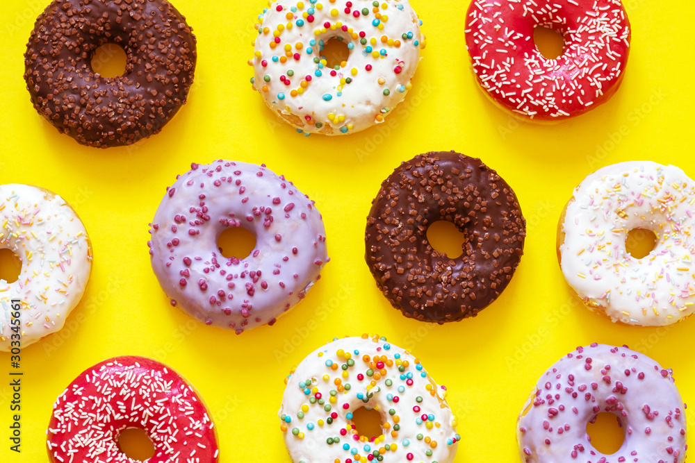 donuts on yellow background, top view donuts on yellow background, top view