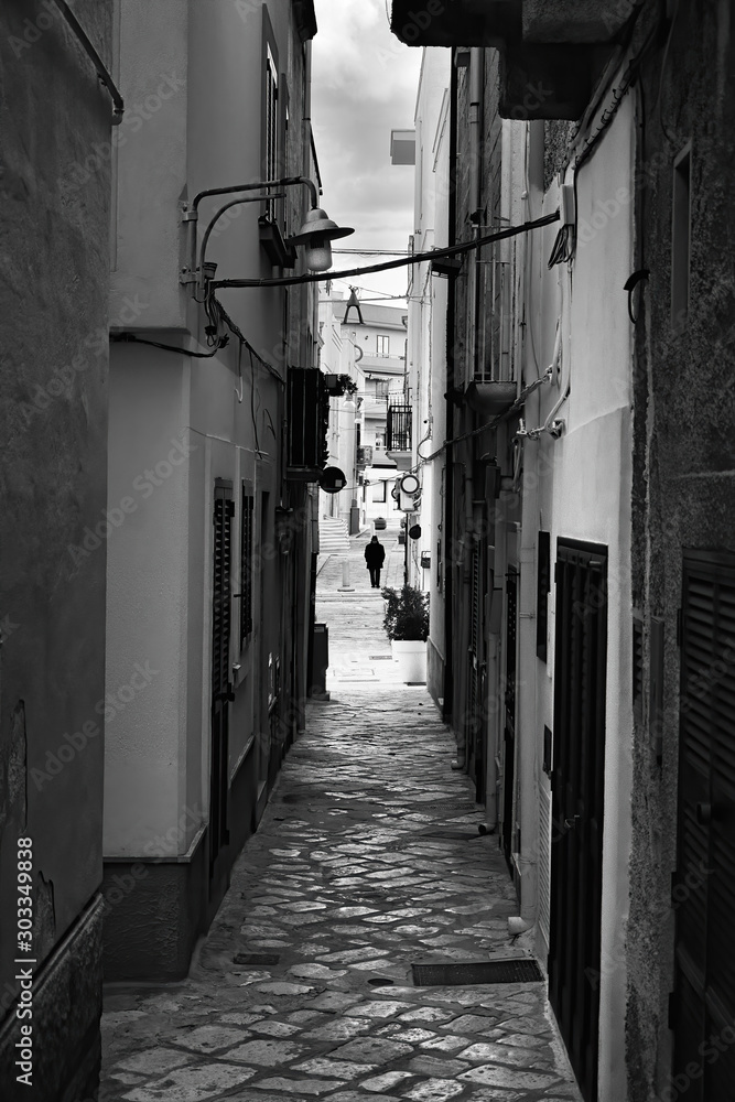 Fototapeta premium Evening winter on the streets of Polignano a Mare Old Town, Bari Province, Puglia region, southern Italy. Black and white image.