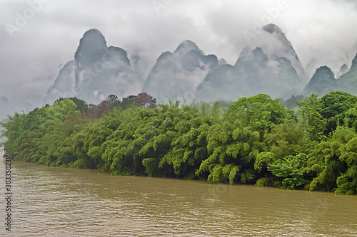 Mysterious clouds and dense vegetation bordering the Li River in the vicinity of Yangshuo near Guilin