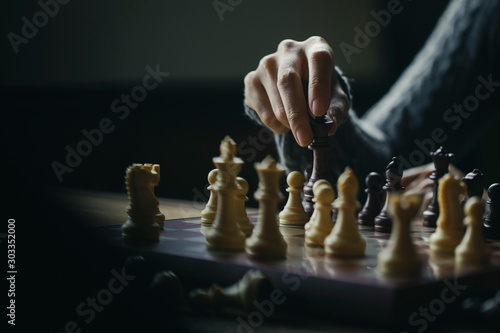 Close up shot hand of young woman playing chess for business challenge competition winner concept