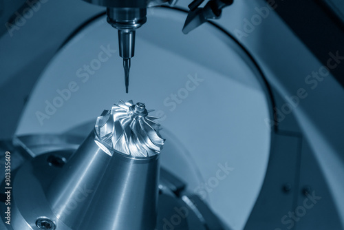 The  5-axis CNC milling machine  cutting the hi-precision automotive  by solid ball endmill tools. The hi technology of impeller parts of turbocharger manufacturing process by 5-axis machining center. photo