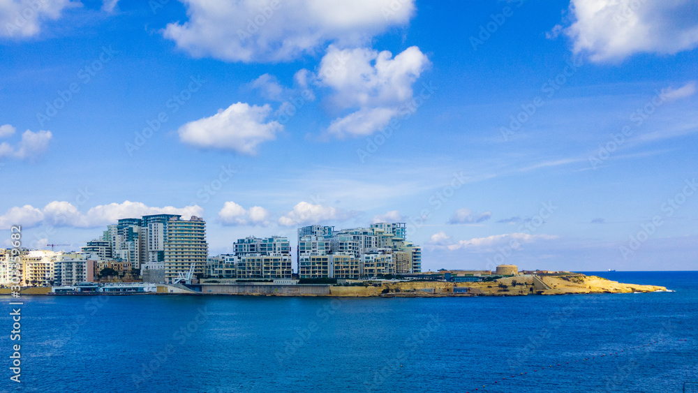 Tigne Point at the end tip of Sliema with its modern apartments next to Fort Tigne which is one of the oldest polygonal forts in the world built by the Order of Saint John in the 18th century.