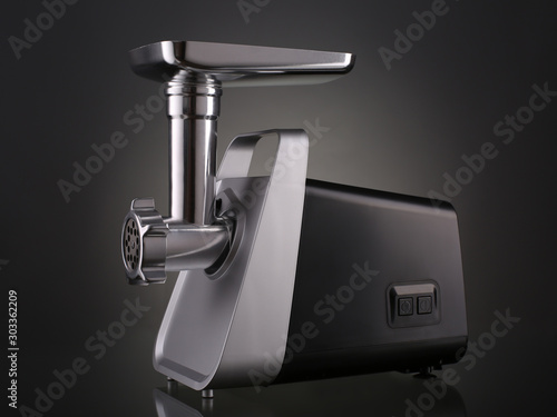 Electric meat grinder on gradient background