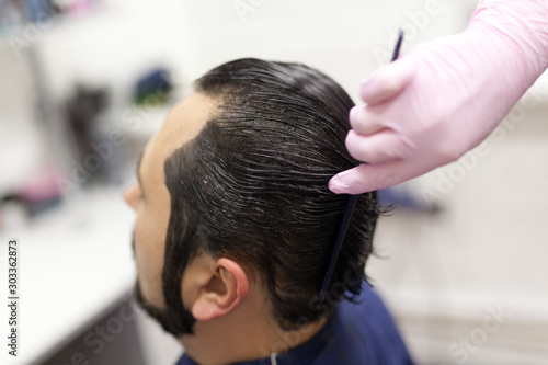 man getting trendy haircut at barber shop