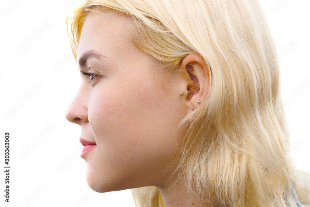 Close up profile portrait of an attractive, woman with blonde hair and a serious expression Close up profile portrait of an attractive, woman with blonde hair and a serious expression