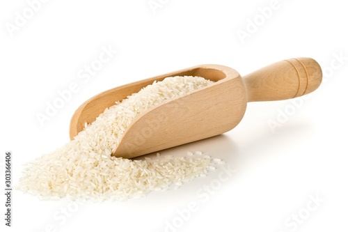 Heap of white uncooked, raw long grain rice in wooden scoop on white