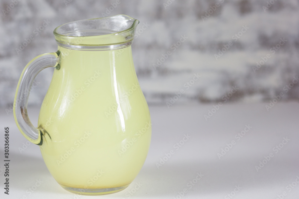 Liquid whey that remains after formation of curds in jar on white background Liquid whey that remains after formation of curds in jar on white background